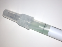 picture of a plastic tube holding a sample of saliva mixed with blue liquid